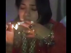 Indian tipsy babe indulges in risqué talk while lighting up, showcasing her uninhibited side and leaving little to the imagination.